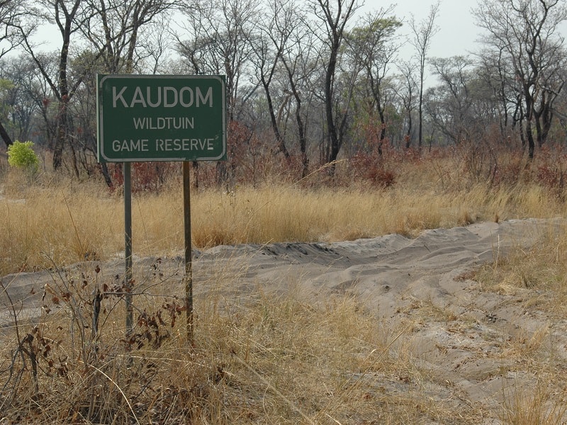 Kaudom Signpost in Front of Track