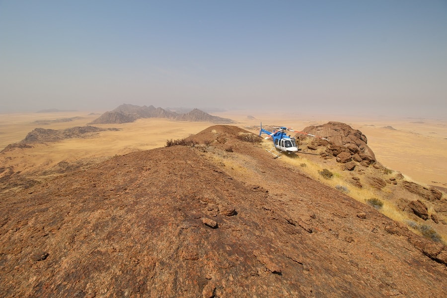 Helicopter on grassy Mountain Top