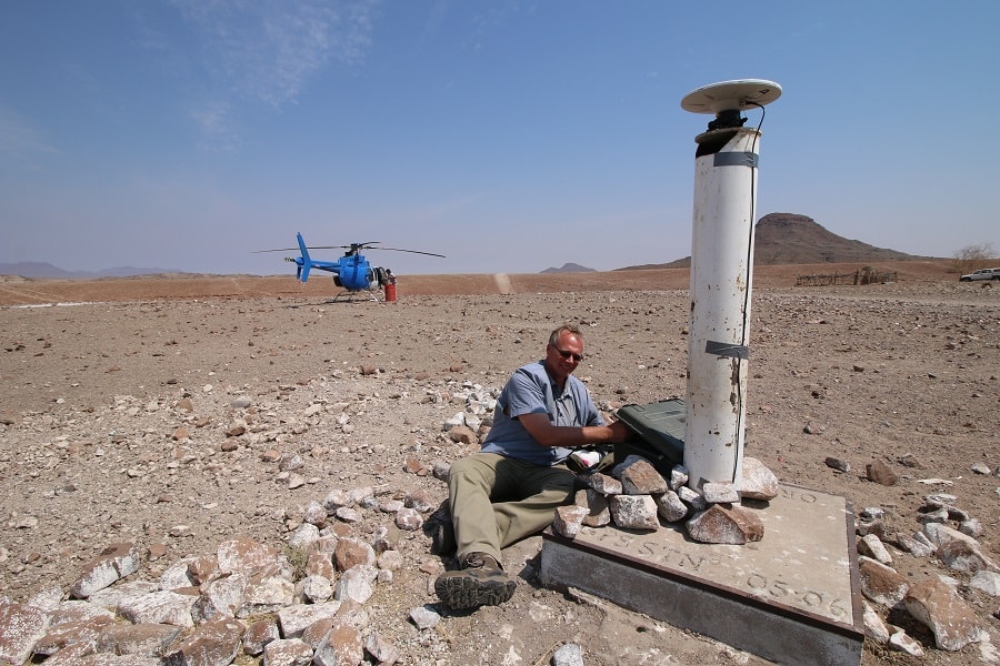 Wilko next to Pillar with Helicopter in Background