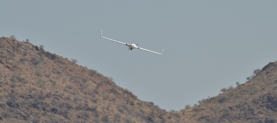 Flying Fixed-Wing Drone in Front of 
			      Mountain